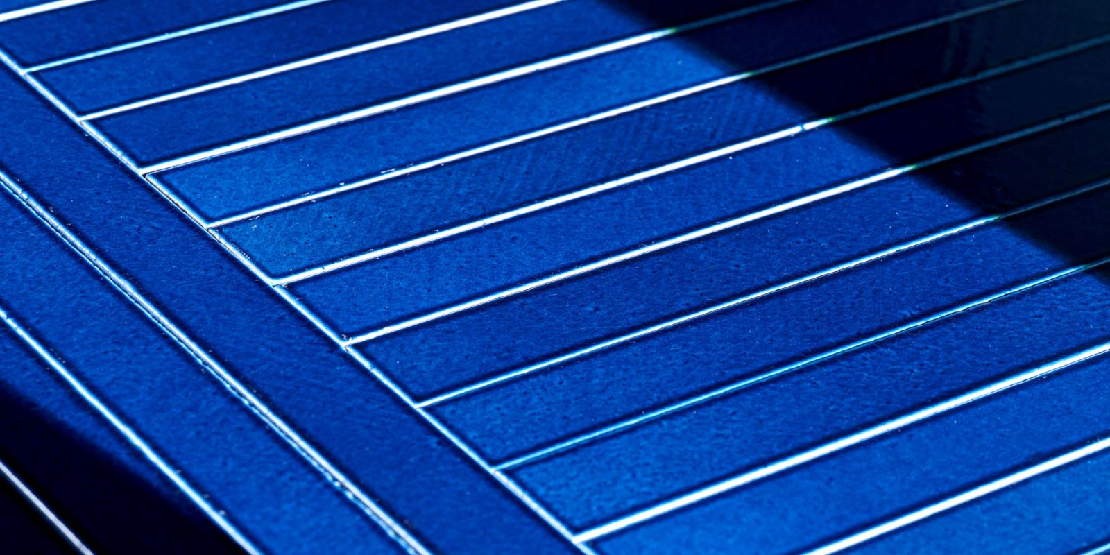 Griglia di piastrelle in pietra lavica smaltata di colore blu vivace con finitura lucida e craquelé.