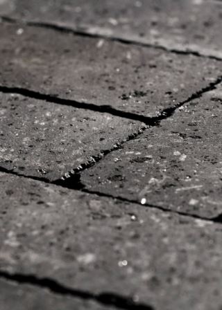 Brown-toned bare lava stone slab with mineral veins, perfect for luxury projects.